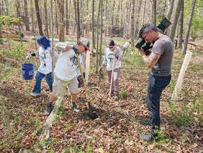 A small inset image from a Blue Ridge Wildlife Center newsletter showing an Earth Day scene at the center.