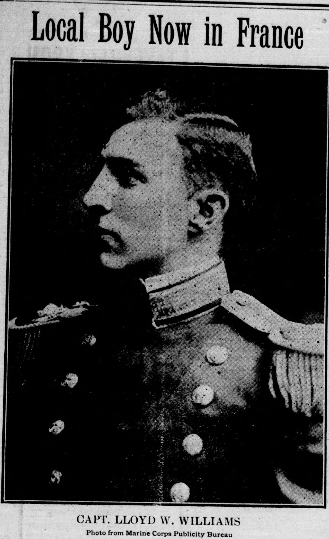 A front-page newspaper photograph headed Local Boy Now in France: a young officer in profile, in a dark dress uniform with a high collar, shoulder boards and buttons, with the caption Capt. Lloyd W. Williams, photo from Marine Corps Publicity Bureau.
