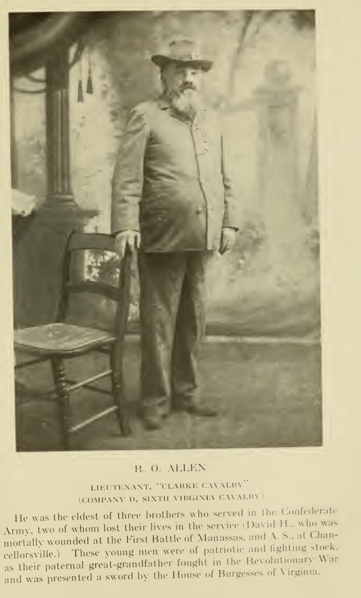 A full-length photograph of R. O. Allen, a heavy-set bearded man in a slouch hat and a buttoned coat, standing with one hand on the back of a chair before a painted backdrop, with the printed caption R. O. Allen, Lieutenant, Clarke Cavalry, Company D, Sixth Virginia Cavalry, and a paragraph on his brothers.
